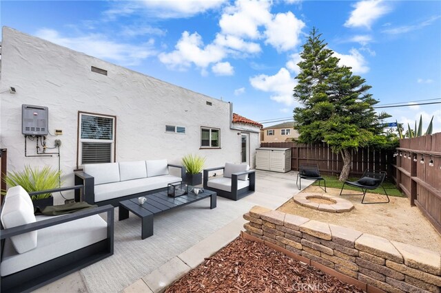 view of patio / terrace featuring an outdoor living space with a fire pit