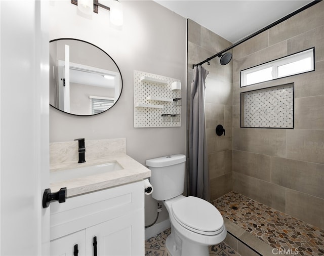 bathroom with vanity, curtained shower, and toilet