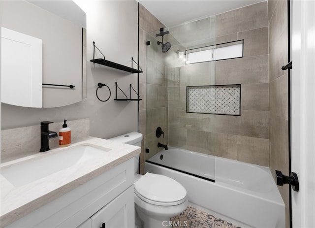 full bathroom with bath / shower combo with glass door, vanity, and toilet