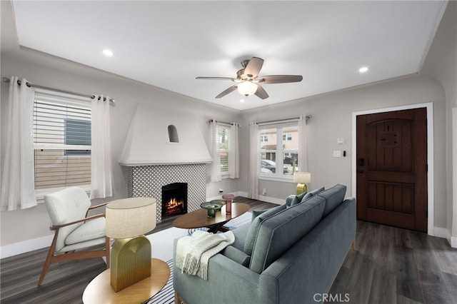 living room featuring a fireplace, dark hardwood / wood-style floors, and ceiling fan