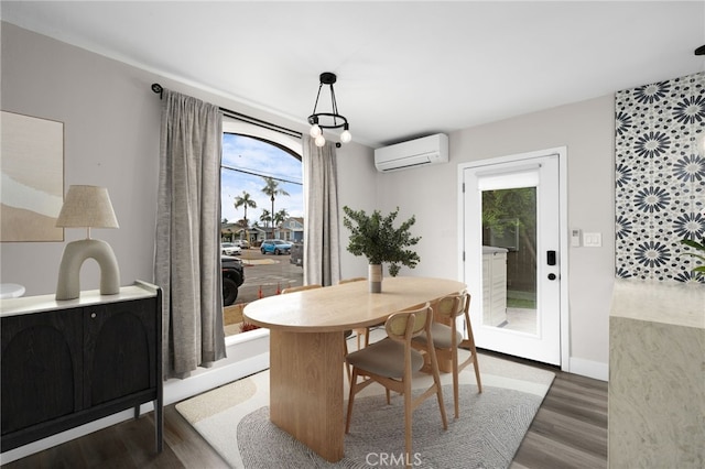 dining area featuring dark wood-type flooring and an AC wall unit