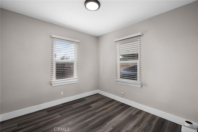 spare room featuring dark wood-type flooring