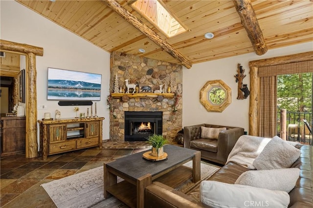 living room with vaulted ceiling, a stone fireplace, and wood ceiling