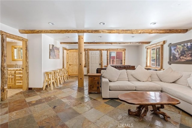 living room with beamed ceiling and sink