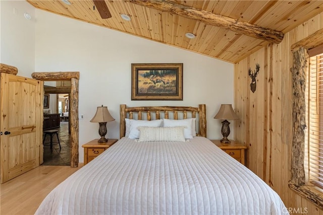 bedroom with wood ceiling, light hardwood / wood-style floors, and lofted ceiling with beams