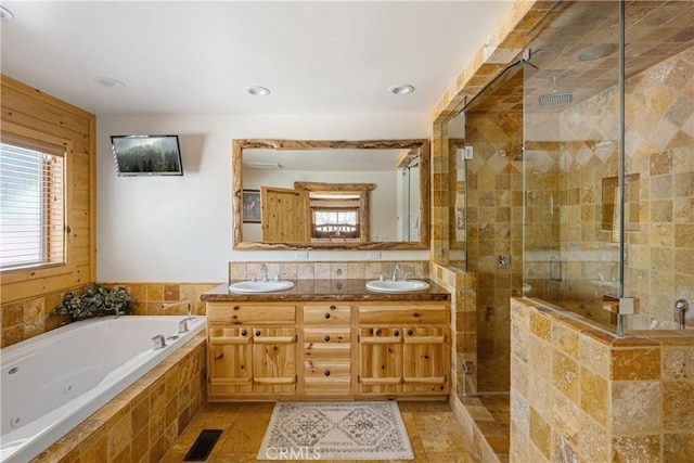 bathroom with vanity and independent shower and bath