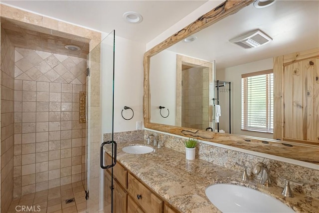 bathroom featuring vanity and a shower with door