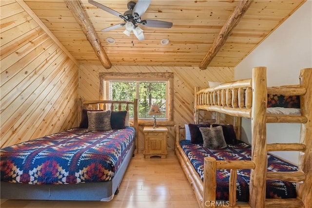 bedroom featuring hardwood / wood-style flooring, vaulted ceiling with beams, wooden ceiling, and wood walls