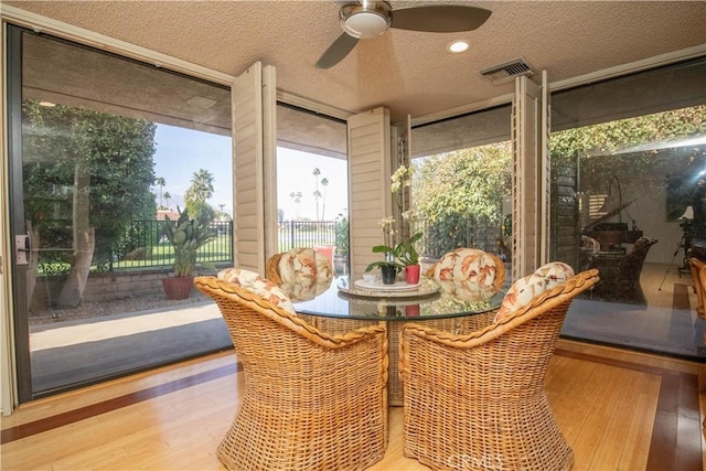 sunroom / solarium featuring ceiling fan