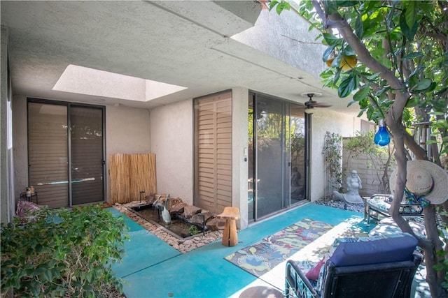 exterior space with ceiling fan and a patio