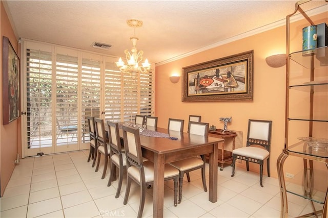 dining room featuring crown molding, light tile patterned flooring, a textured ceiling, and a chandelier