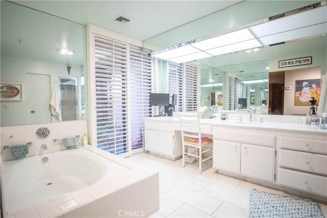 bathroom with independent shower and bath, vanity, and tile patterned floors