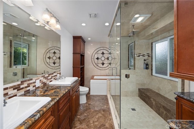 bathroom with vanity, an enclosed shower, and toilet