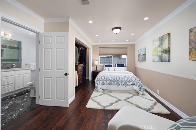 bedroom featuring dark wood-type flooring, ensuite bathroom, crown molding, and sink