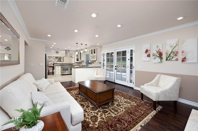 living room with crown molding and hardwood / wood-style floors