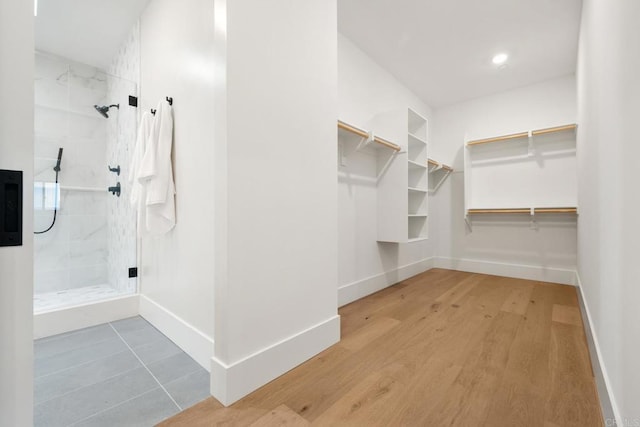 spacious closet with hardwood / wood-style flooring