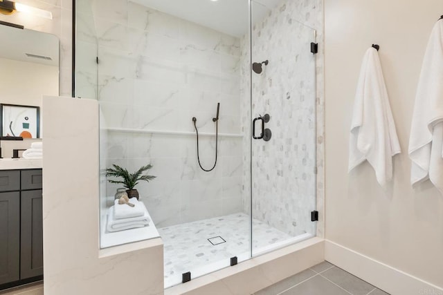 bathroom with tile patterned floors, vanity, and a shower with shower door