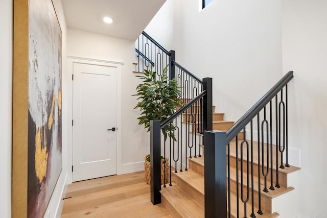 stairs featuring wood-type flooring