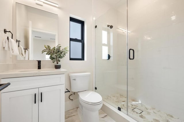 bathroom featuring walk in shower, vanity, and toilet