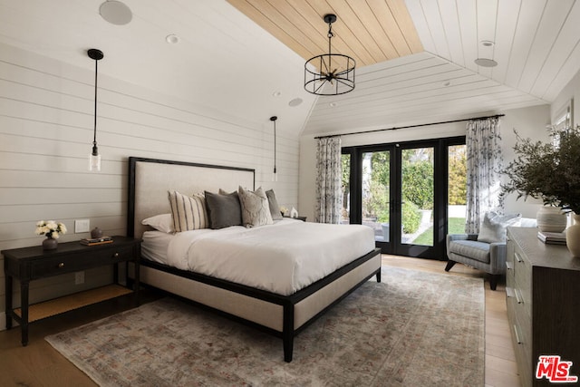 bedroom featuring lofted ceiling, wood ceiling, wood-type flooring, access to outside, and french doors