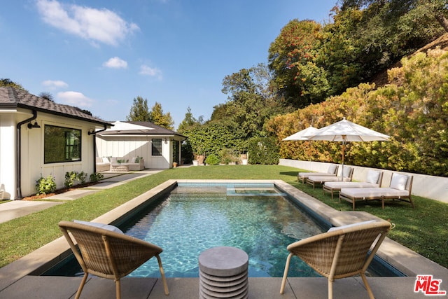 view of swimming pool with an outdoor structure, a patio area, a lawn, and a hot tub