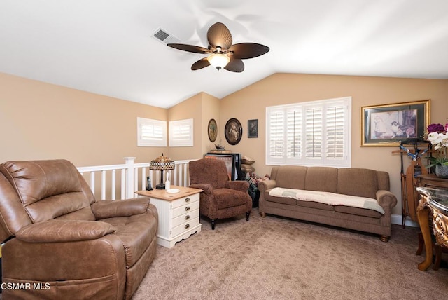 carpeted living room featuring ceiling fan and vaulted ceiling