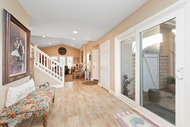 interior space with lofted ceiling and light wood-type flooring