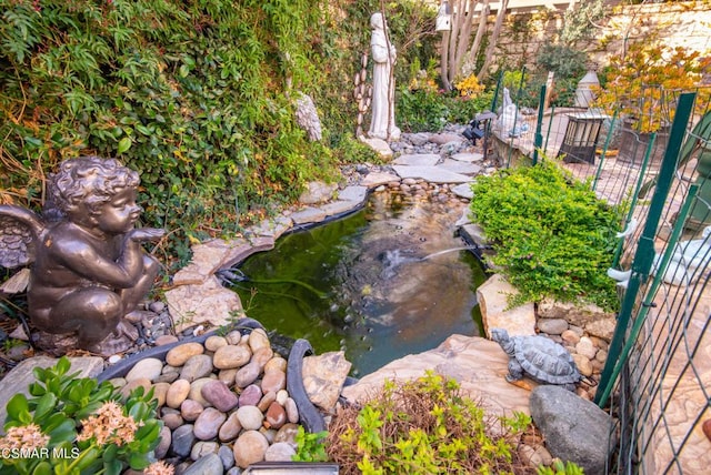 view of yard with a garden pond