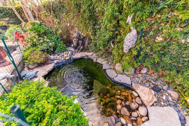 exterior space with a garden pond