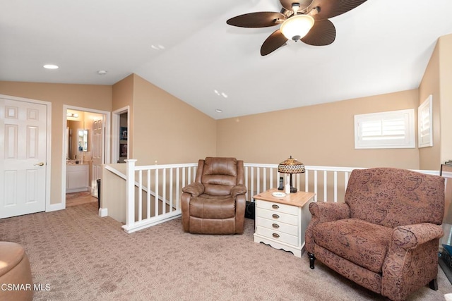 sitting room featuring vaulted ceiling and light carpet