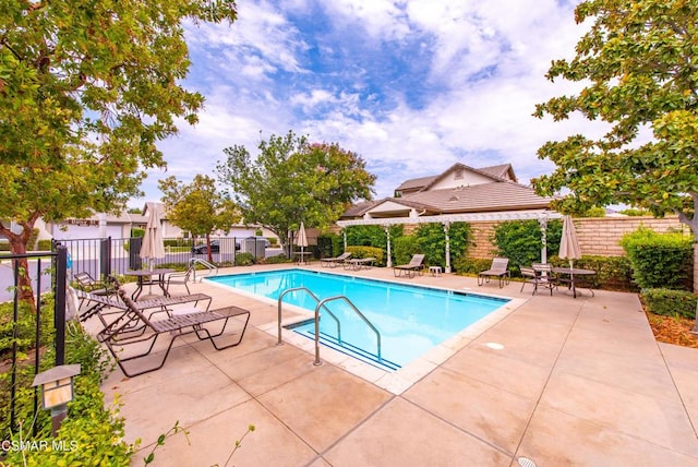 view of swimming pool with a patio area