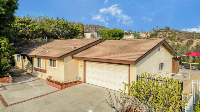 single story home with a mountain view and a garage