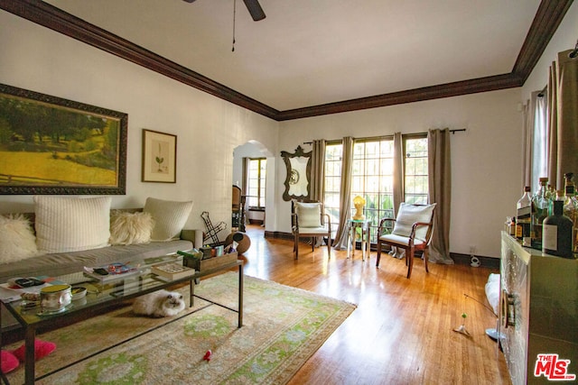 living room featuring crown molding, ceiling fan, and light hardwood / wood-style floors