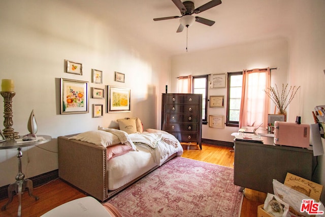 bedroom with ceiling fan and light hardwood / wood-style flooring