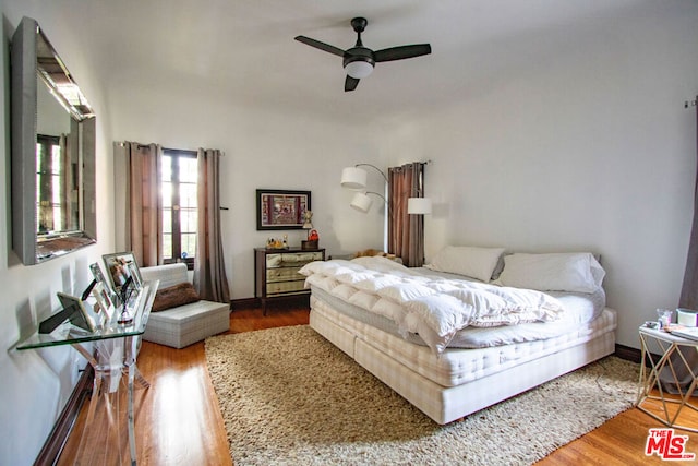 bedroom featuring wood-type flooring and ceiling fan