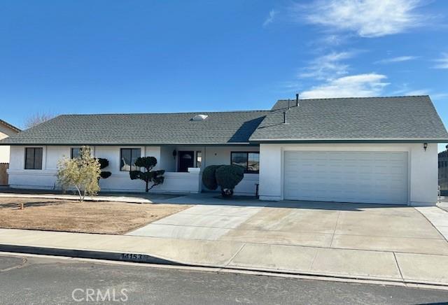 ranch-style home featuring a garage