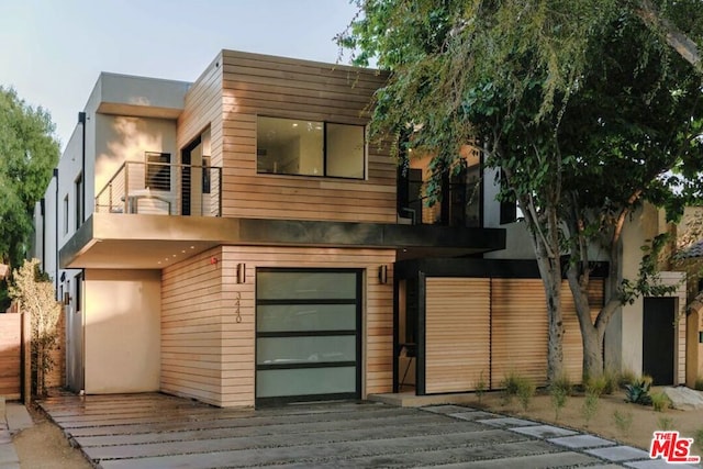 modern home featuring a balcony and a garage