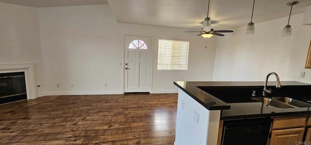 kitchen featuring dark hardwood / wood-style flooring, hanging light fixtures, dark stone counters, and ceiling fan