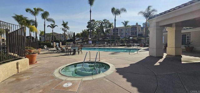 view of swimming pool with a patio area and a community hot tub