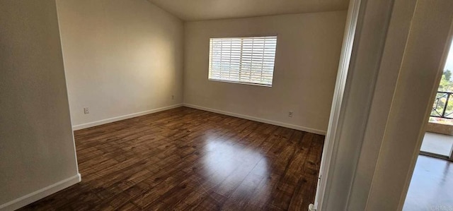 empty room featuring dark hardwood / wood-style flooring