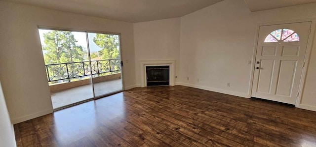 unfurnished living room featuring dark hardwood / wood-style floors