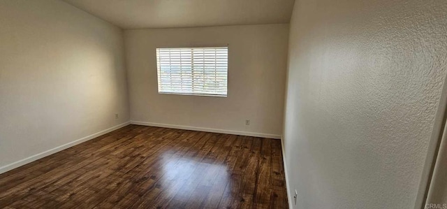 unfurnished room featuring dark wood-type flooring