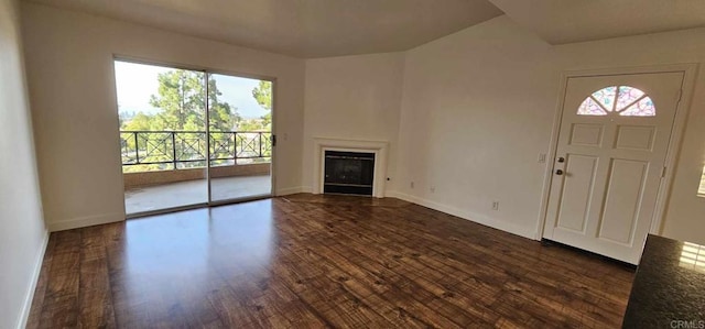 unfurnished living room with dark wood-type flooring