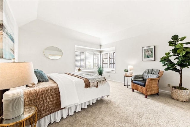 bedroom featuring carpet floors, vaulted ceiling, and baseboards