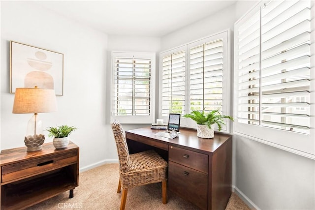 office featuring baseboards and light colored carpet