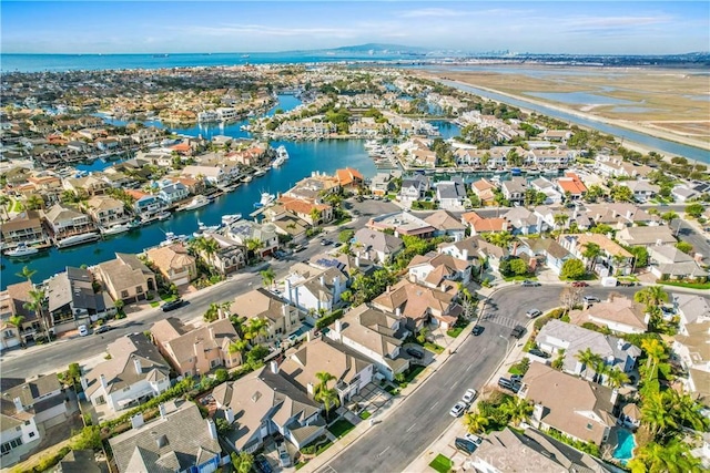 drone / aerial view with a water view and a residential view