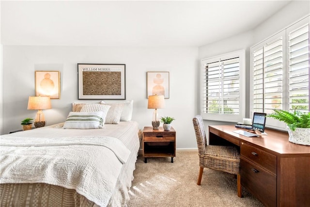 bedroom with light carpet and baseboards