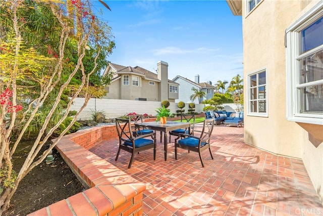 view of patio / terrace featuring outdoor dining space, outdoor lounge area, and a fenced backyard