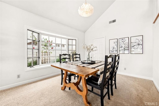 dining space featuring baseboards, visible vents, carpet floors, high vaulted ceiling, and a notable chandelier