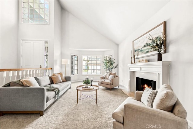 living room with carpet floors and high vaulted ceiling